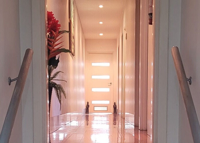 Tranquil hallway at Jindaa Thai Massage, Bendigo, Victoria, AU with soft lighting and floral decor.