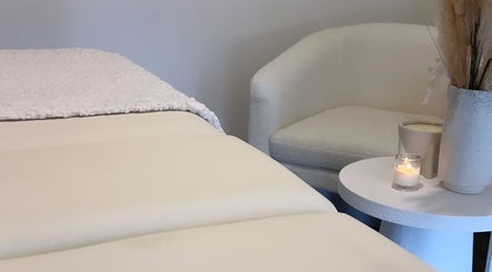 Calming spa room at JSbrowbar_ with cozy chair and candlelit ambiance, Melbourne, Victoria, AU.