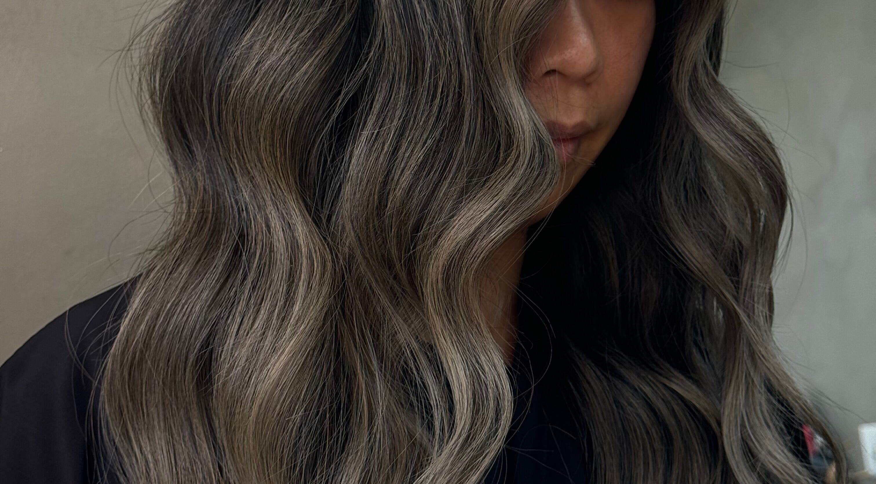 Elegant wavy hairstyle by Estrella Salon in San Diego, California, US. Perfect for a stylish makeover.