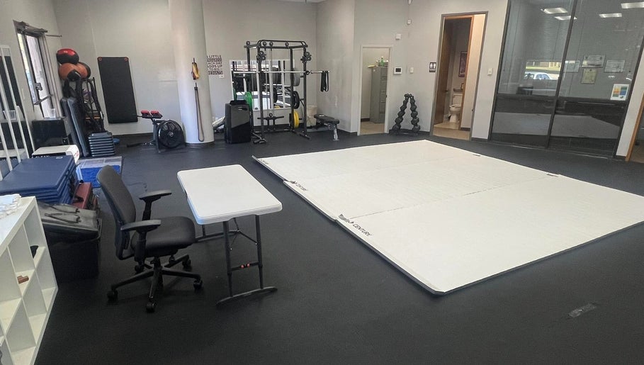 Spacious training area in Warrior’s Edge, Dallas, Texas, US, featuring exercise equipment and mats.