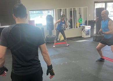 People in a workout session at Warrior’s Edge, Dallas, Texas, US, using resistance bands.