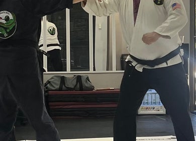 Martial arts lesson at Warrior’s Edge, Dallas, Texas, US showcasing two practitioners in action.