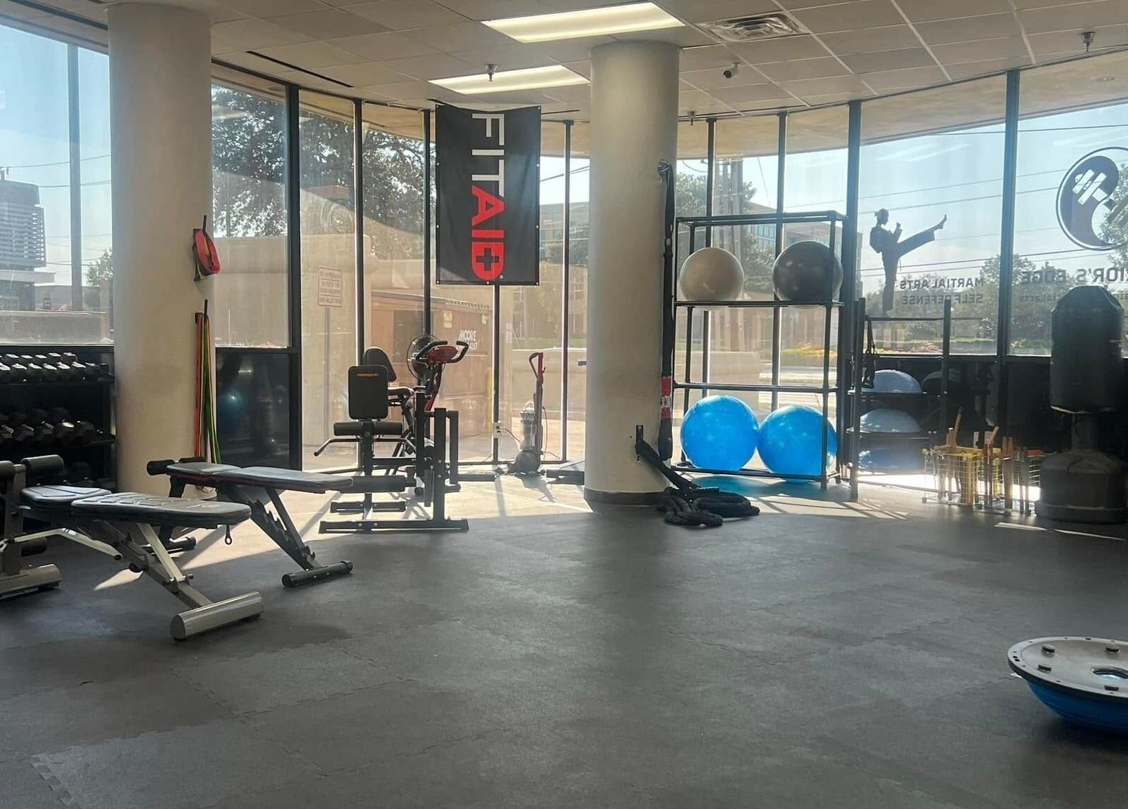 Spacious gym at Warrior’s Edge in Dallas, Texas, US, with modern equipment and bright windows.