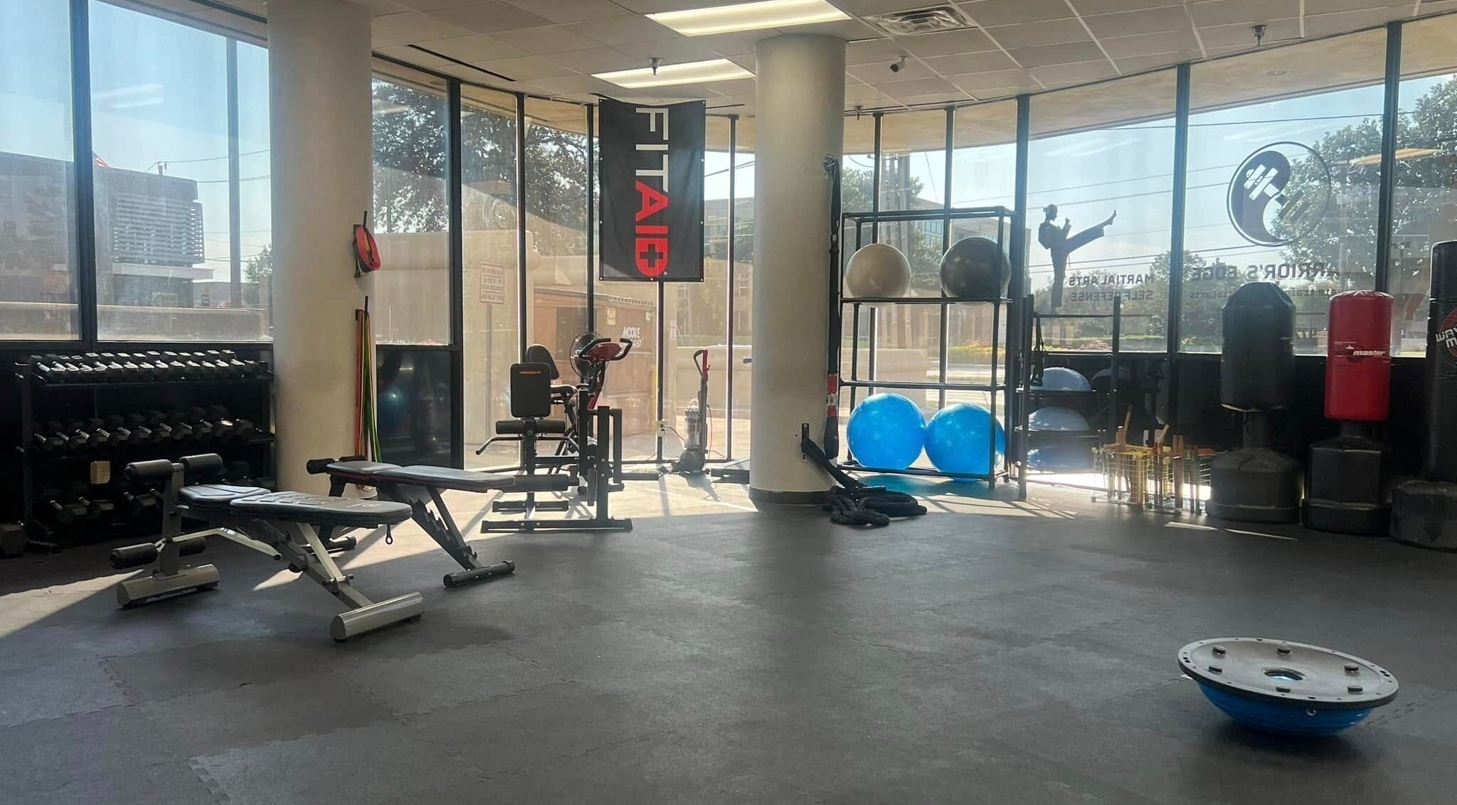Spacious gym at Warrior’s Edge in Dallas, Texas, US, with modern equipment and bright windows.