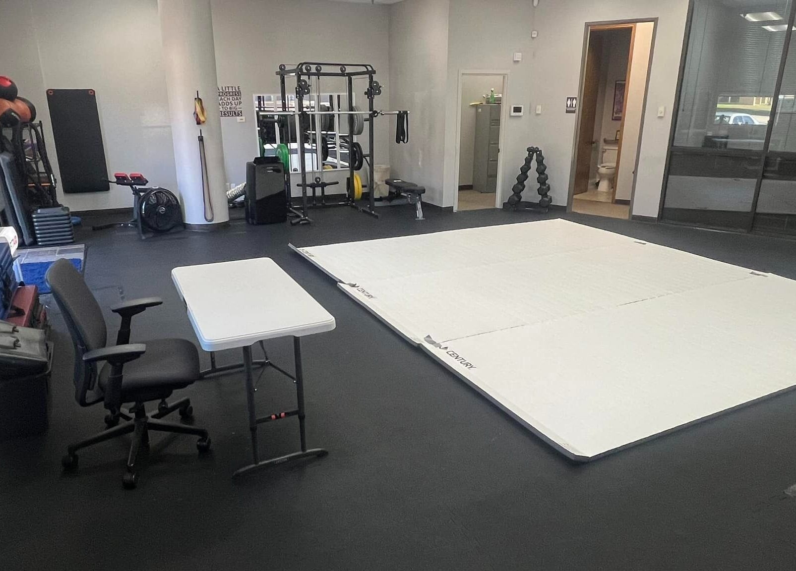 Spacious gym training area at Warrior’s Edge, Dallas, Texas, US, featuring fitness mats and equipment.