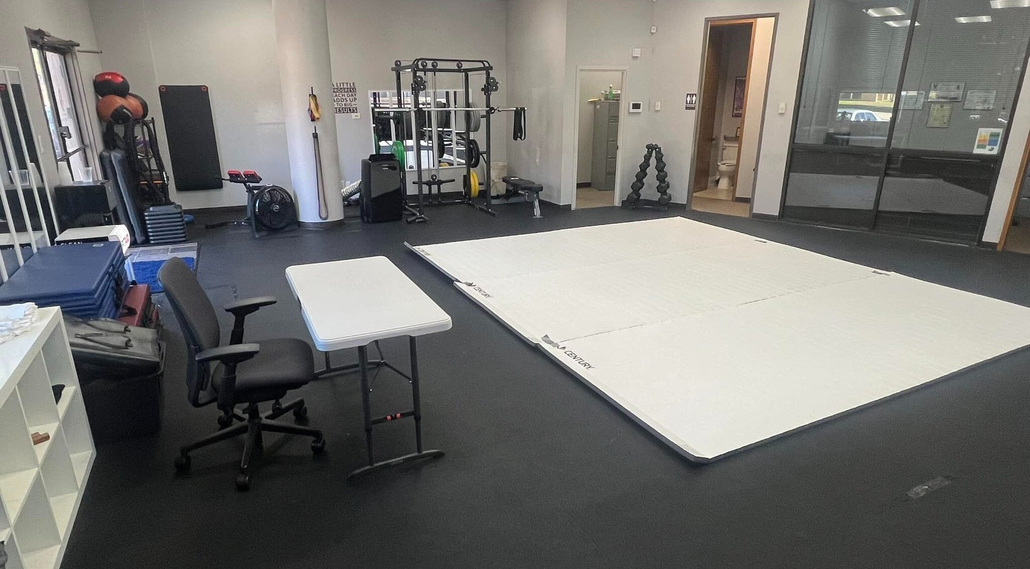 Spacious gym training area at Warrior’s Edge, Dallas, Texas, US, featuring fitness mats and equipment.