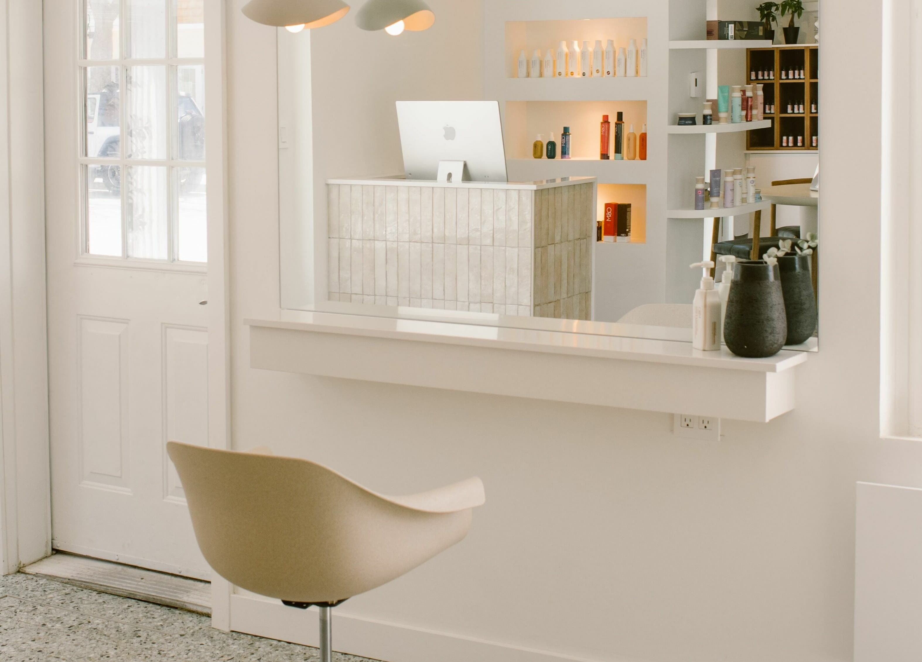 Intérieur élégant et minimaliste de Mane by TK à Pointe-Claire, Québec, CA, montrant accueil moderne.