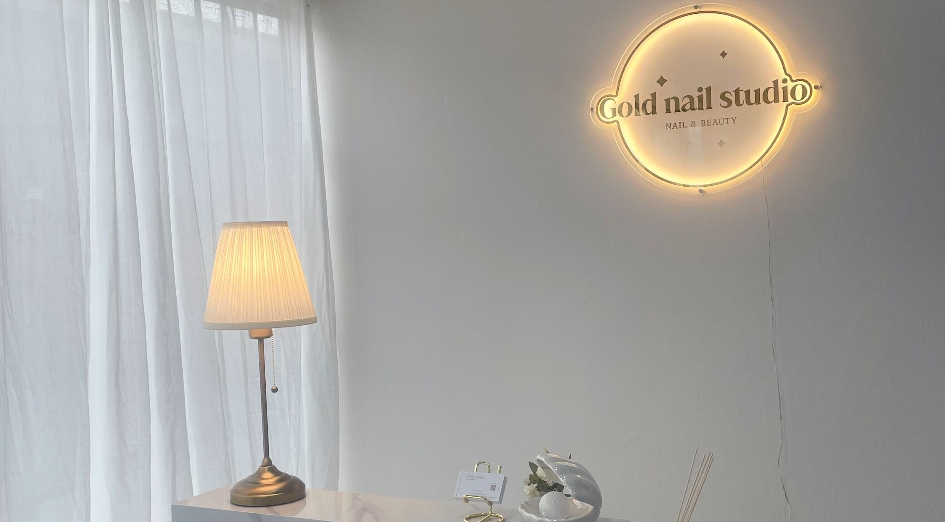 Warmly lit interior of Gold Nail Studio, Ardross, Western Australia, AU showcasing cozy ambiance and chic decor.