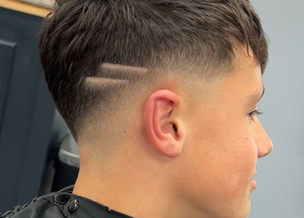 Close-up of a stylish fade haircut with shaved lines at Eydmanns Barbering, Bognor Regis, England, GB.
