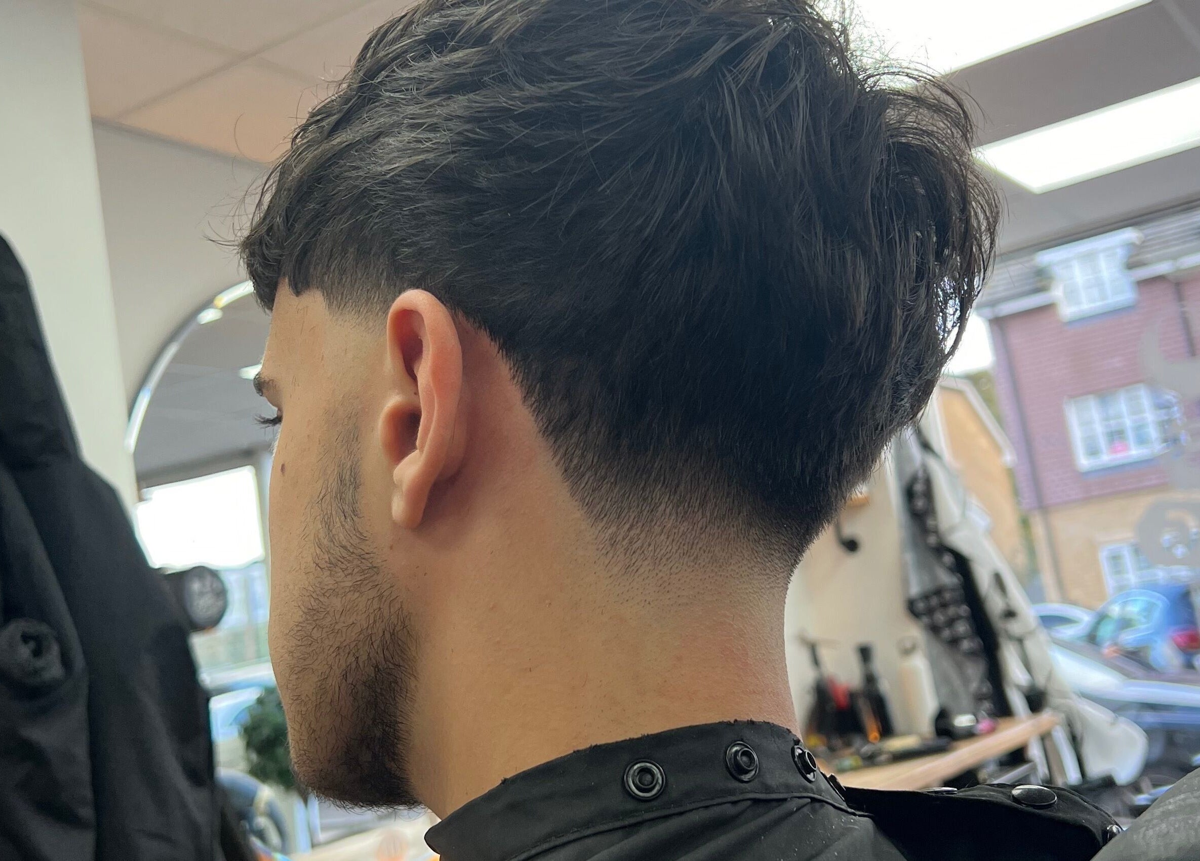 Close-up of a stylish men's haircut at Eydmanns Barbering, Bognor Regis, England, GB, showcasing a sleek fade.