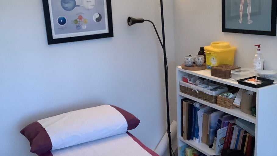 Comfortable treatment room at Jessica Leyland Acupuncture, Southampton, England, GB, with books and equipment.