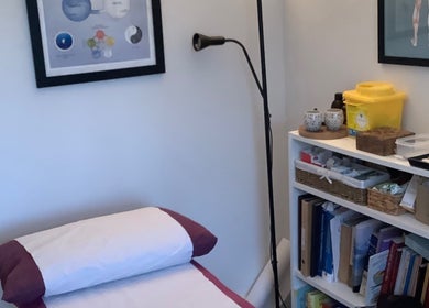 Comfortable treatment room at Jessica Leyland Acupuncture, Southampton, England, GB, with books and equipment.