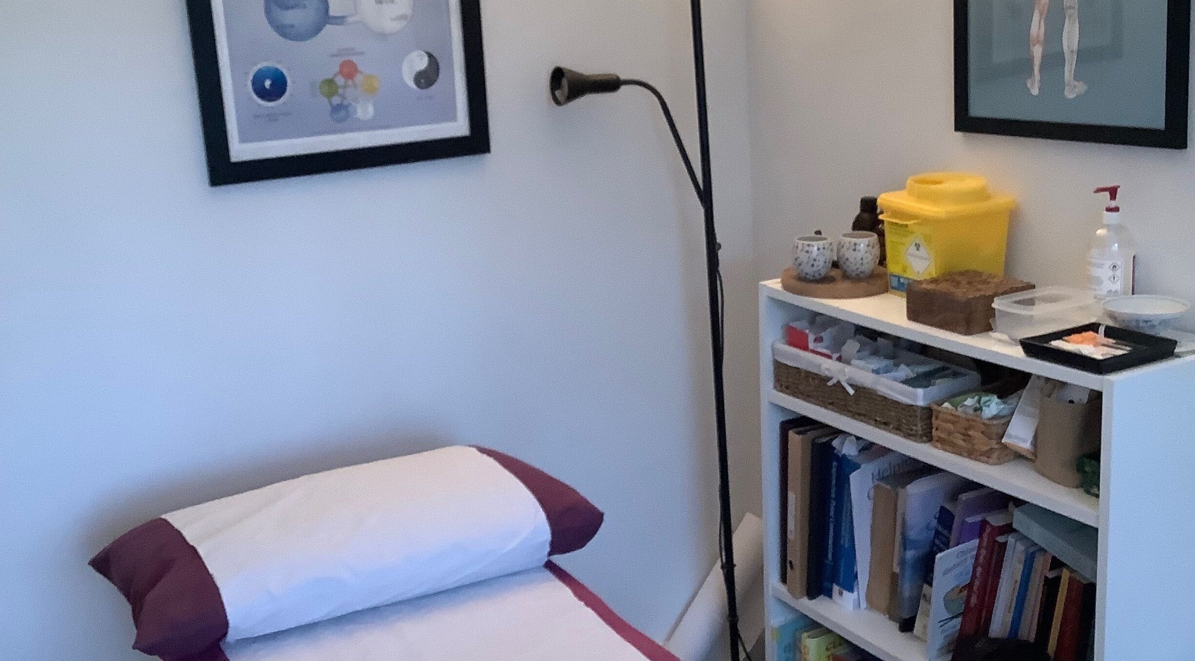 Comfortable treatment room at Jessica Leyland Acupuncture, Southampton, England, GB, with books and equipment.