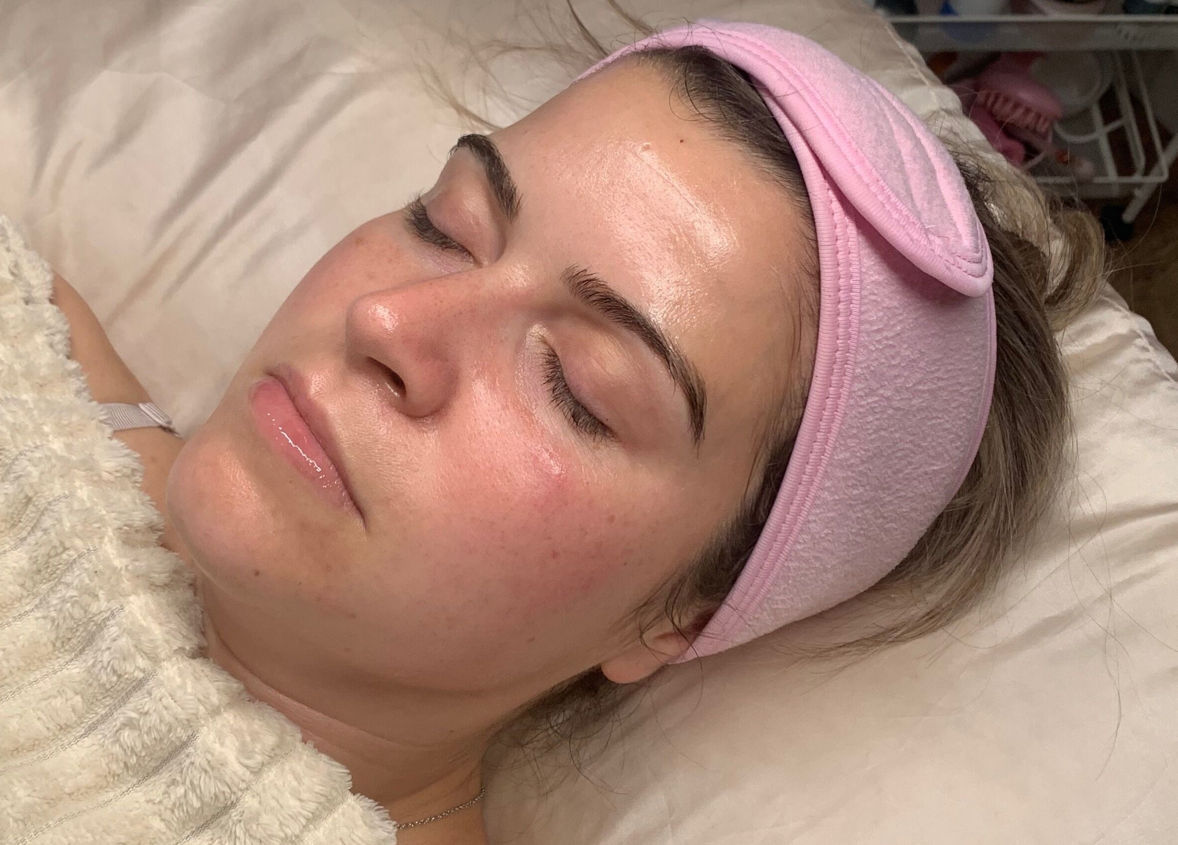 Relaxing facial at Skin Luminosity by Lydia, Southend-on-Sea, England. Client resting with pink headband.