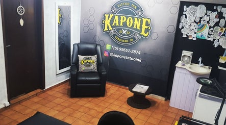 Interior do Kapone Tattoo Ink, São Paulo, SP, com cadeira de tatuagem e decoração artística.
