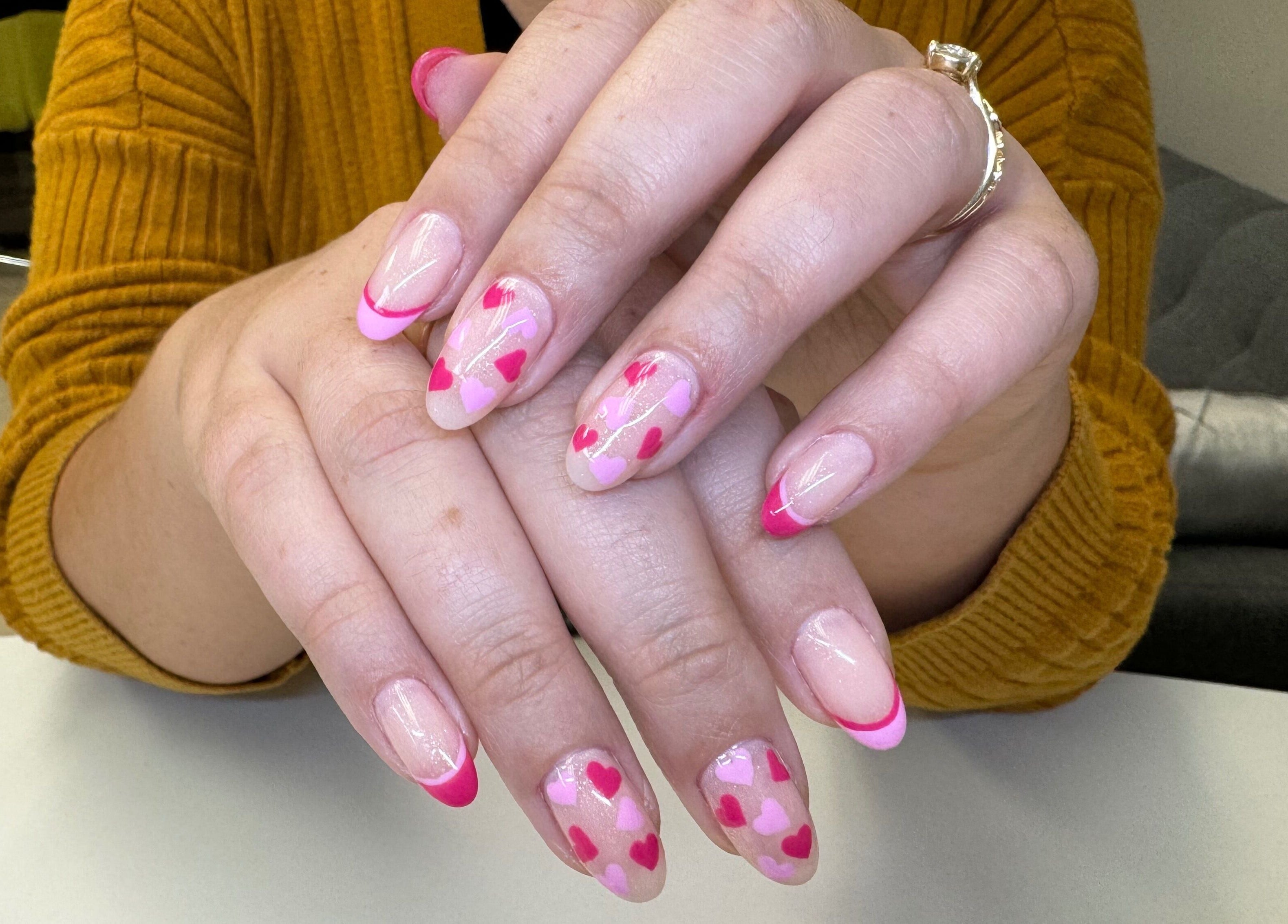 Pink heart nail art at Alana Bee Nails, Margate, Florida, US. Perfectly manicured hands displayed stylishly.