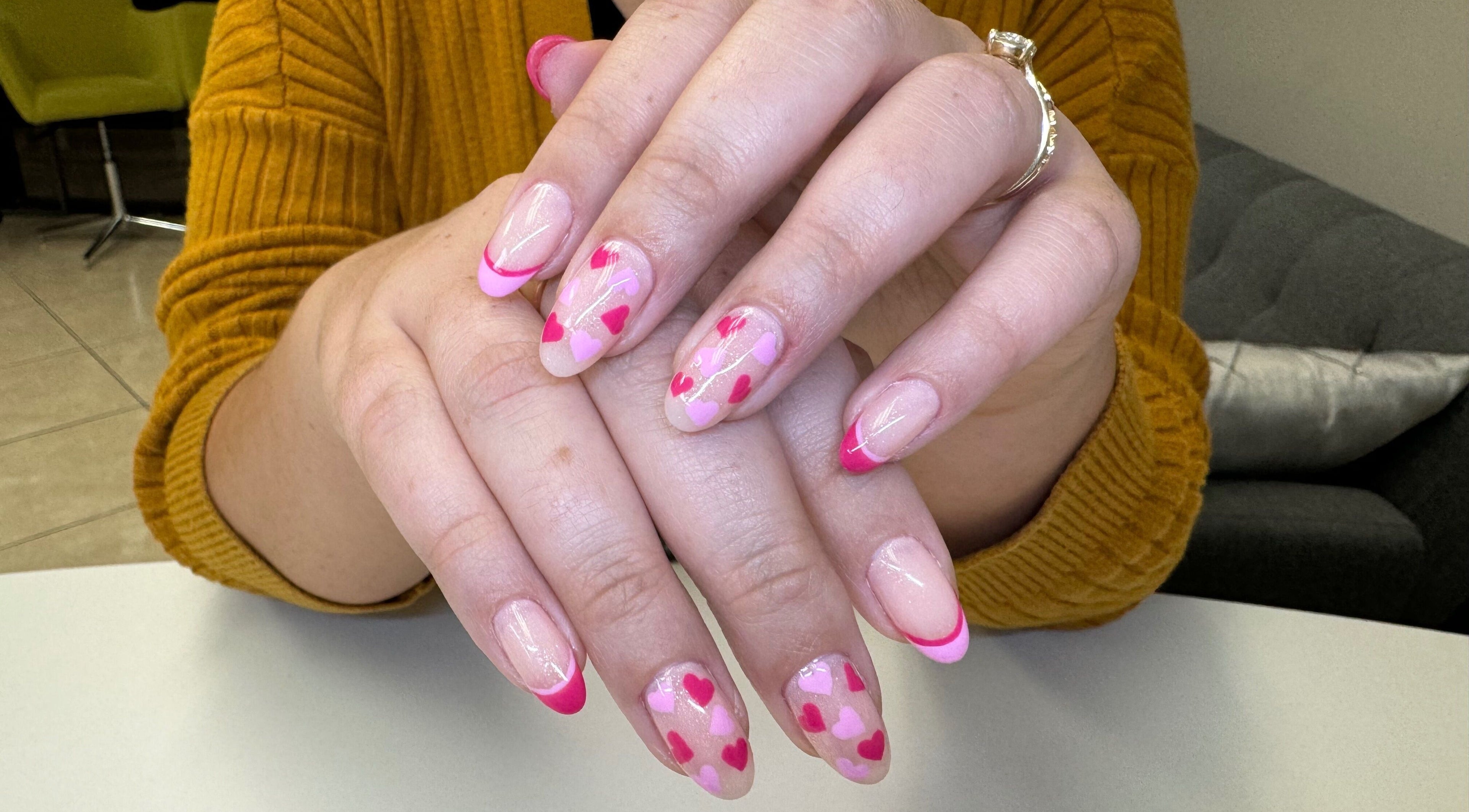 Pink heart nail art at Alana Bee Nails, Margate, Florida, US. Perfectly manicured hands displayed stylishly.