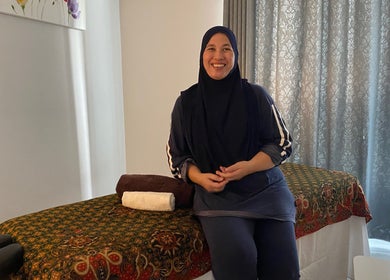 A serene massage setup at MassageByEllisaBahrin with smiling therapist, Selangor, Selangor, MY.