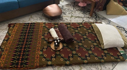 Traditional massage setup at MassageByEllisaBahrin, Selangor, MY, featuring towels and oils.