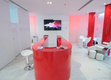 Nailstation's sophisticated salon interior featuring bold red accents, located in Dubai, AE.