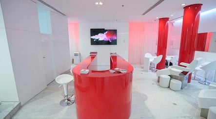 Nailstation's sophisticated salon interior featuring bold red accents, located in Dubai, AE.