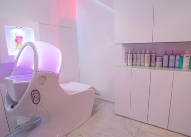 Modern pedicure station at Nailstation, Dubai, AE, featuring luxury spa chair and product display.