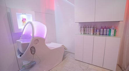 Modern pedicure station at Nailstation, Dubai, AE, featuring luxury spa chair and product display.