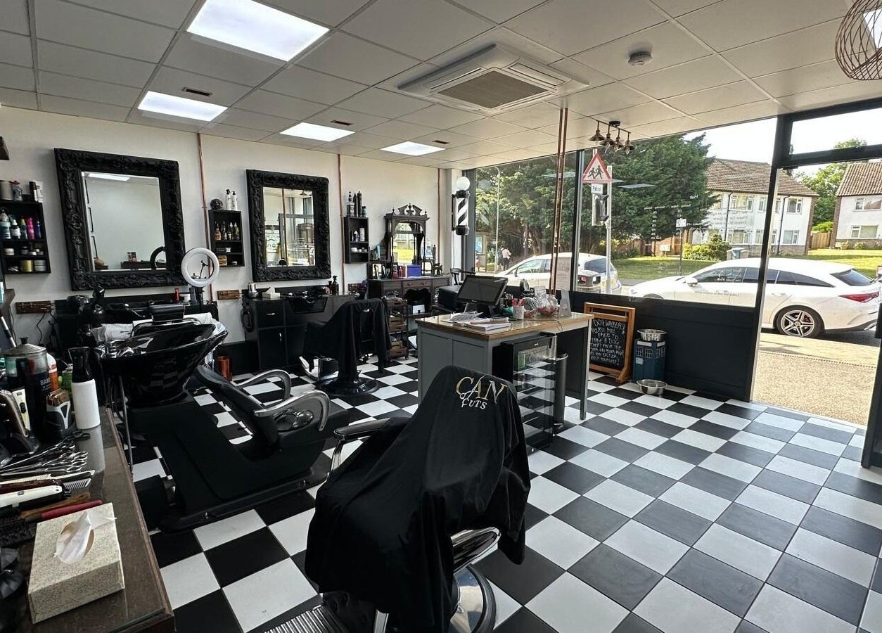 Stylish interior of Can Cuts salon in Orpington, England, GB with checkered floor and modern decor.