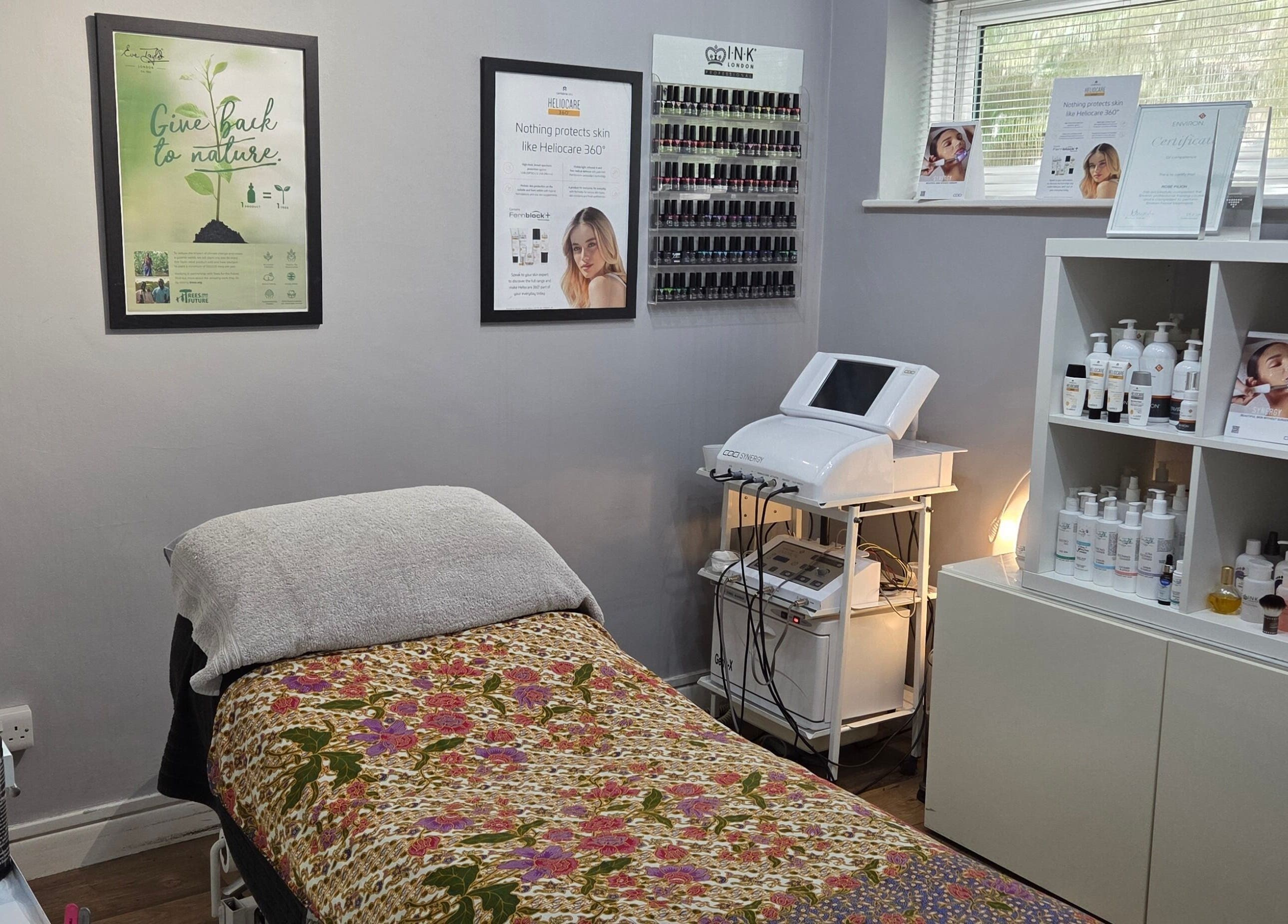 Cozy treatment room at Reflection Skin & Beauty Clinic, Westbourne, England, GB with decorative bedding.