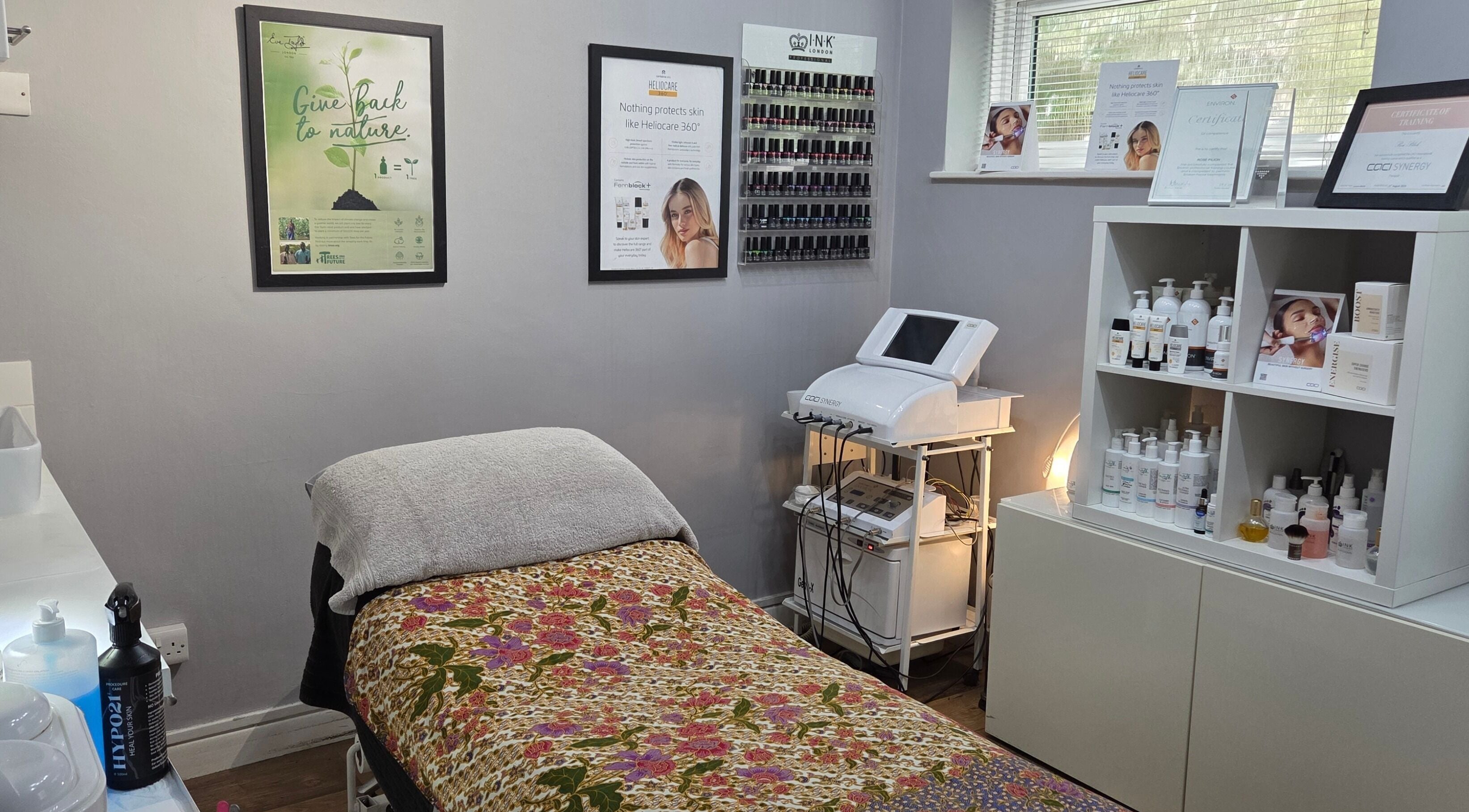 Cozy treatment room at Reflection Skin & Beauty Clinic, Westbourne, England, GB with decorative bedding.