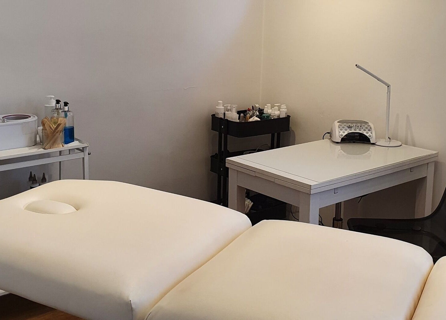 Treatment room at Reflection Skin & Beauty Clinic in Westbourne, England, GB with massage table and skincare tools.