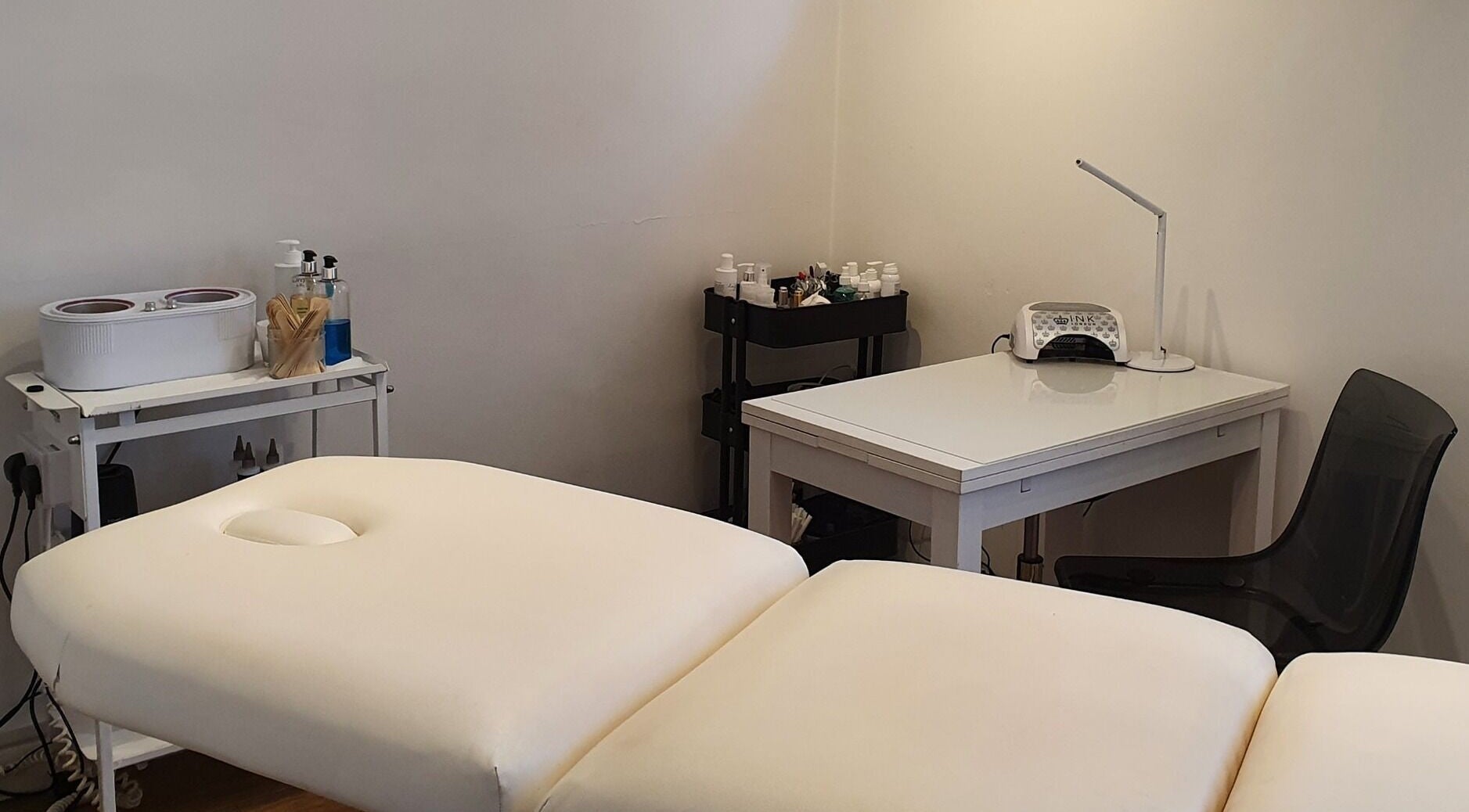 Treatment room at Reflection Skin & Beauty Clinic in Westbourne, England, GB with massage table and skincare tools.