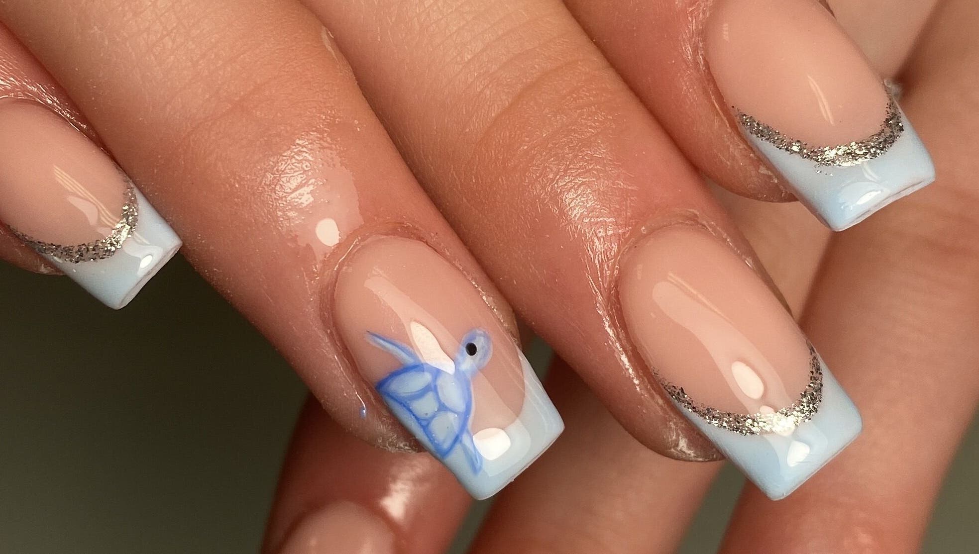 Stylish nail design featuring blue and silver art at The Beauty Studio by Abbie, Delph, England, GB.