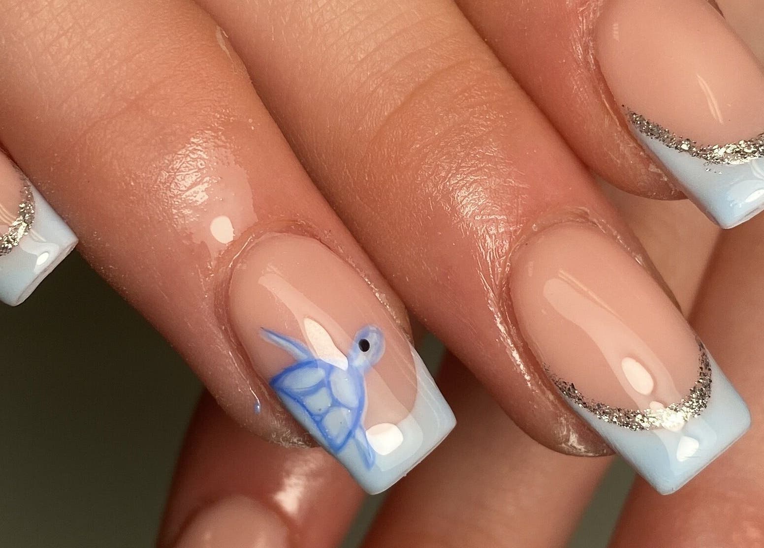 Stylish nail design featuring blue and silver art at The Beauty Studio by Abbie, Delph, England, GB.