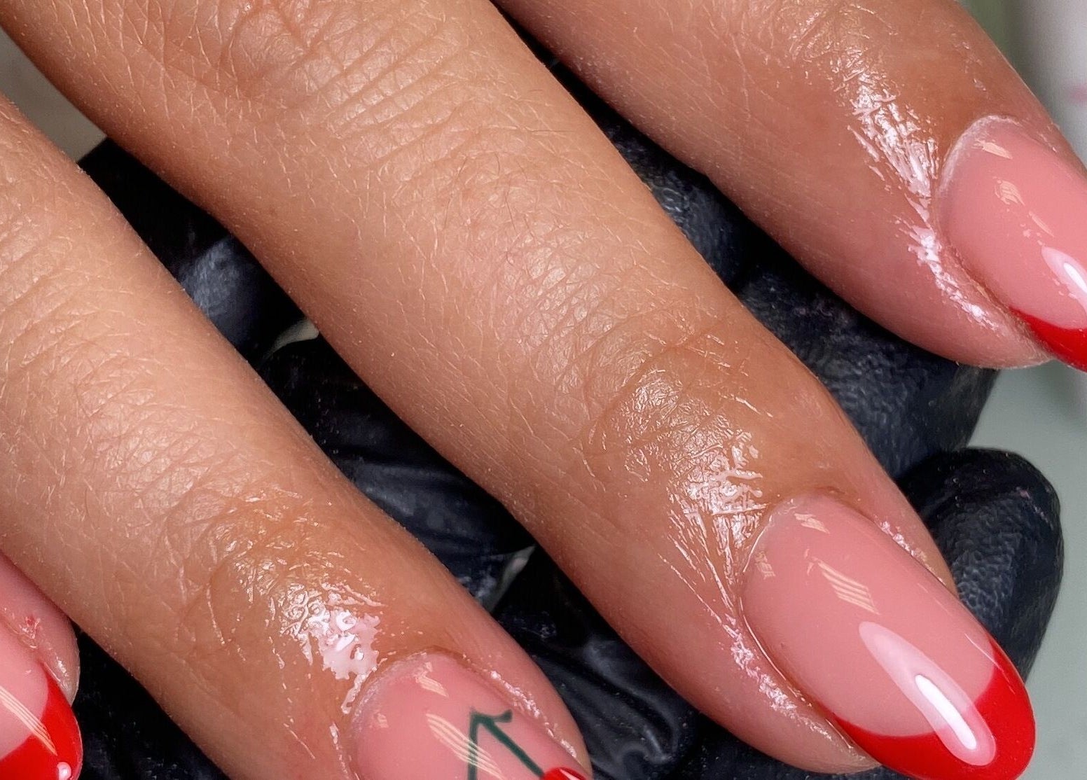 Elegant red-tipped nails at The Beauty Studio by Abbie, Delph, England, GB showcasing expert nail care.