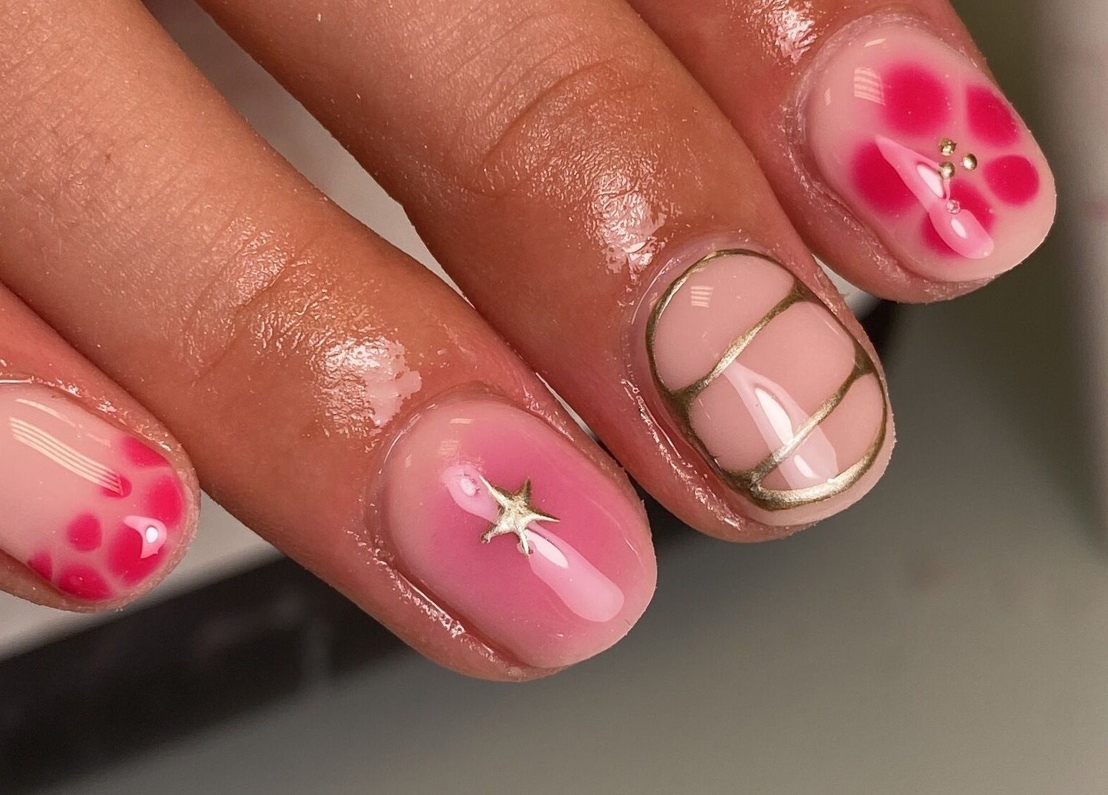 Intricate nail art at The Beauty Studio by Abbie, Delph, England, GB showcasing pink floral designs.