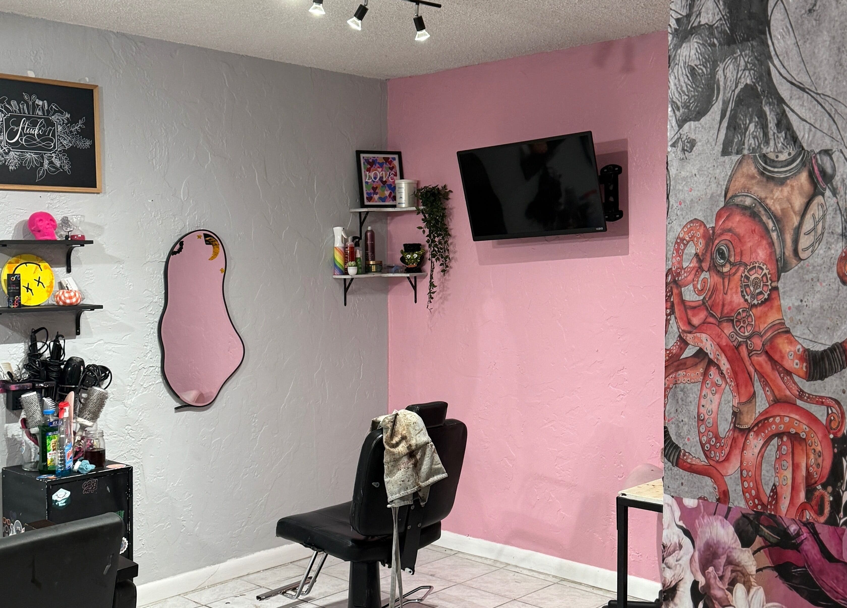 Modern styling chair in pink and gray interior of Studio 17, Cutler Bay, Florida, US.