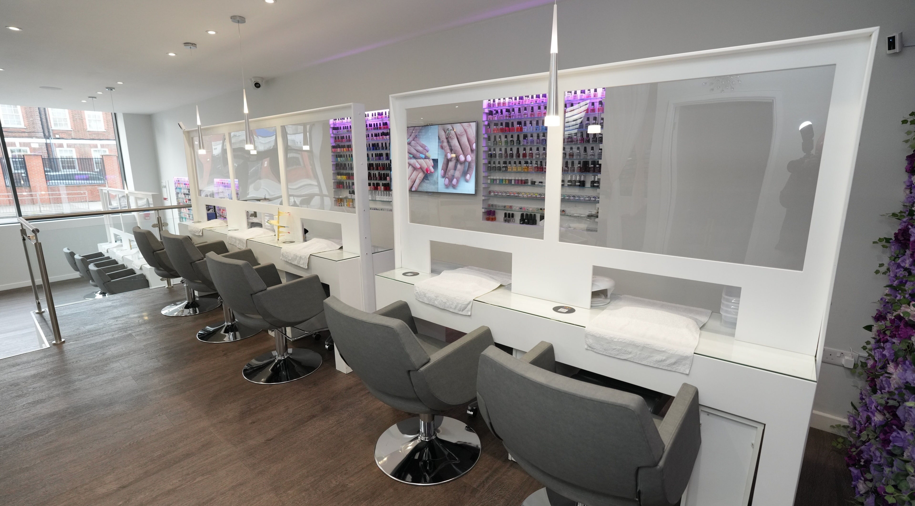 Modern nail station interior at Laska By Mira in Colindale, England, GB with chic decor and natural light.