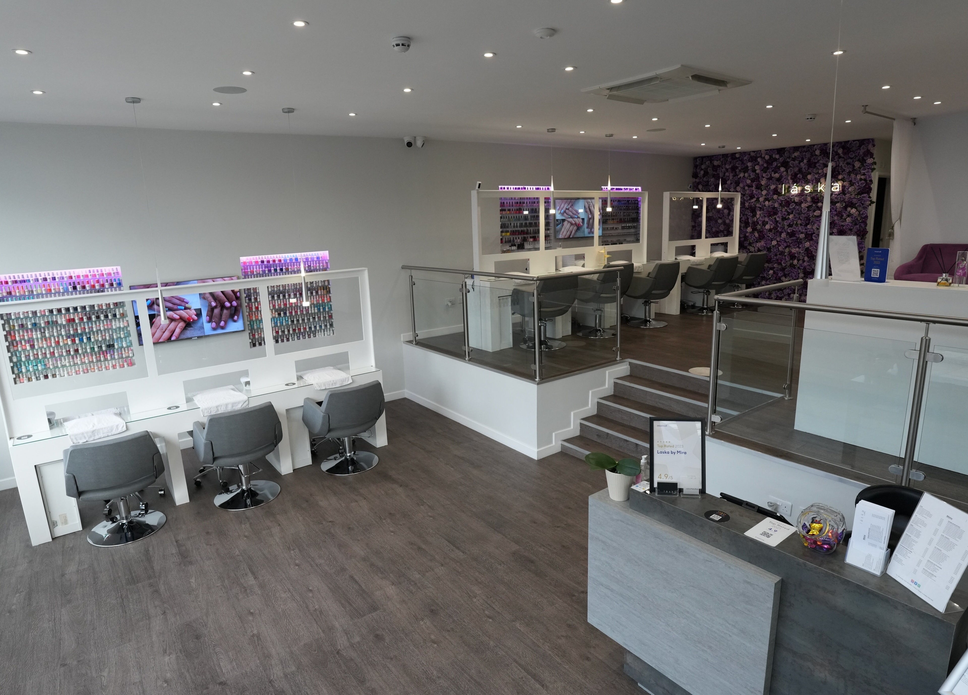 Modern interior of Laska By Mira in Colindale, England, showcasing stylish nail stations and chic decor.