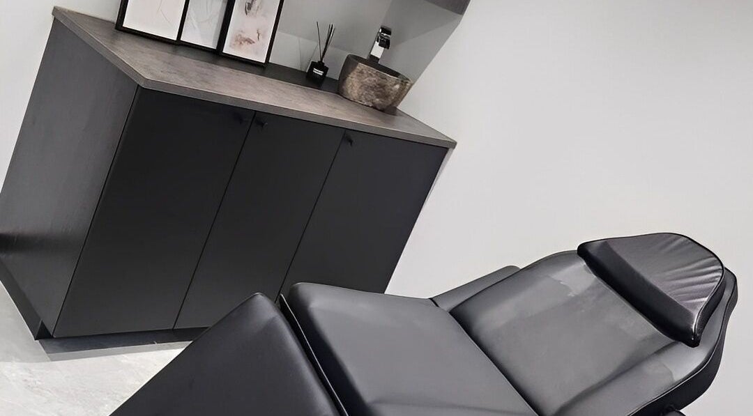 Modern treatment room at Salon Underground in Longridge, England, GB with a stylish black massage bed.