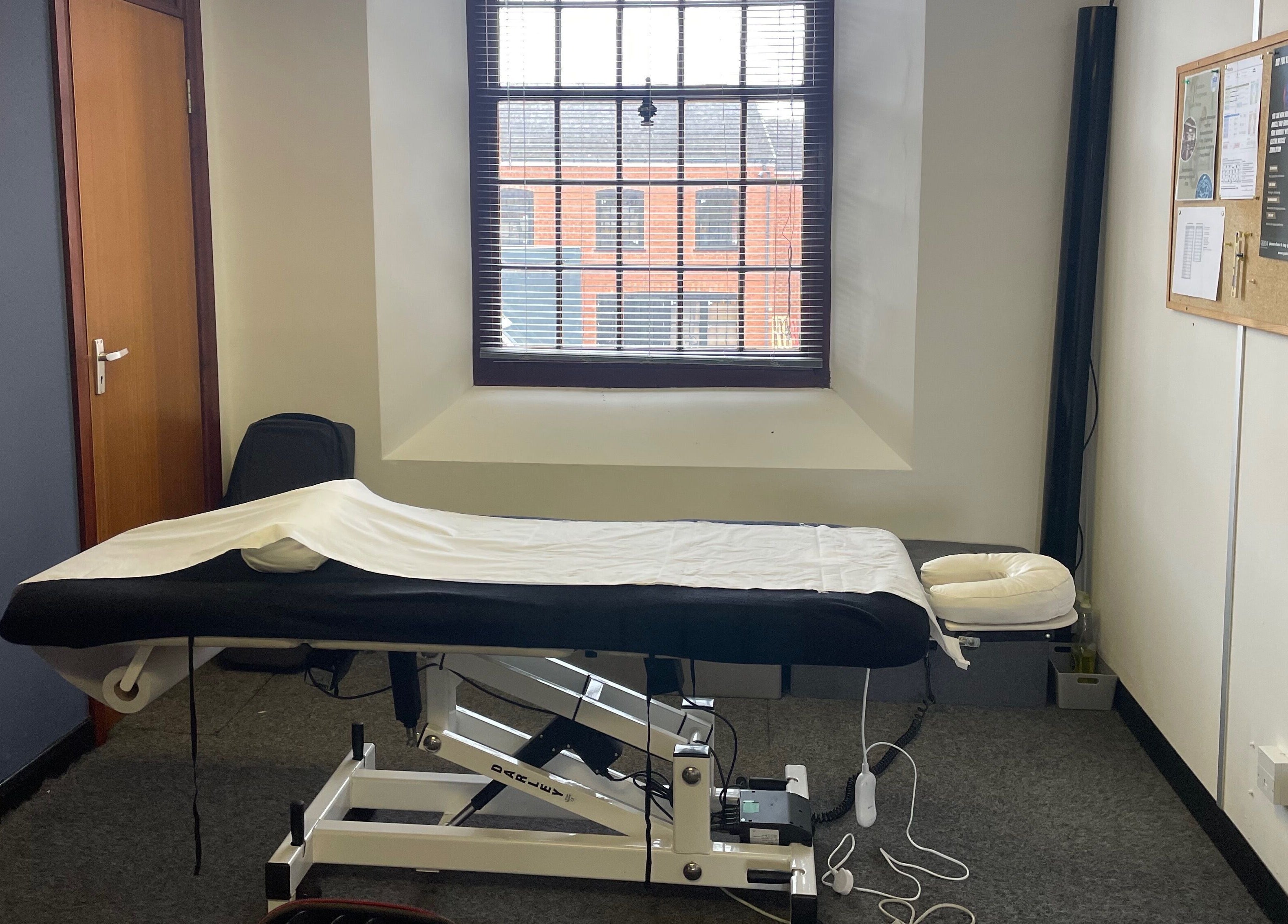 Relaxing spa room at Emerj Fit, Retford, England, GB. Features a massage table beneath a large window.