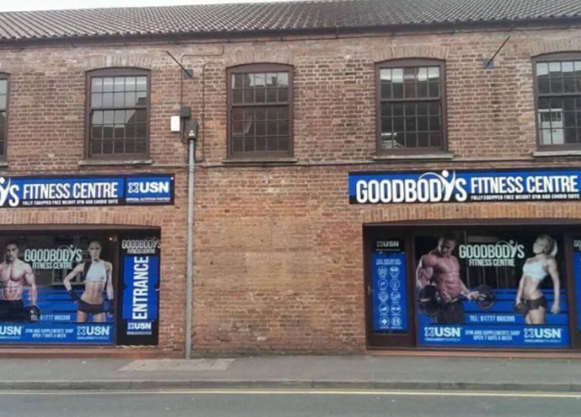Emerj Fit entrance at Retford, England, GB, showcasing fitness posters on a brick building front.