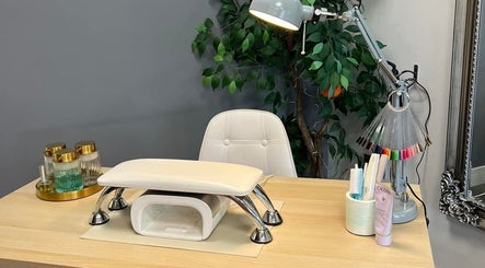 Cozy nail station at Atmillies, Scunthorpe, England, GB with tools, lamp, and greenery for a relaxing experience.