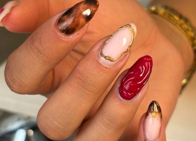 Stylish nail art with marble and red accents at Atmillies, Scunthorpe, England, GB.