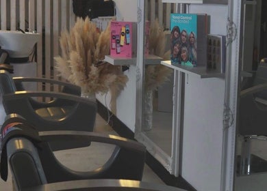 Interior of The White Hair salon in Barnsley, England, showcasing modern styling chairs and elegant decor.