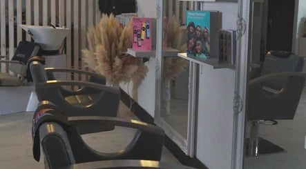 Interior of The White Hair salon in Barnsley, England, showcasing modern styling chairs and elegant decor.