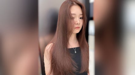 A woman with long, sleek hair styled at Cosmo Hair Salon, Melbourne, Victoria, AU.