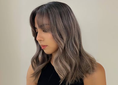 Woman showcasing stylish wavy hair at Cosmo Hair Salon, Melbourne, Victoria, AU.