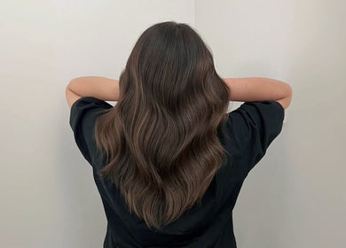 Back view of long, wavy hair styled at Cosmo Hair Salon in Melbourne, Victoria, AU.