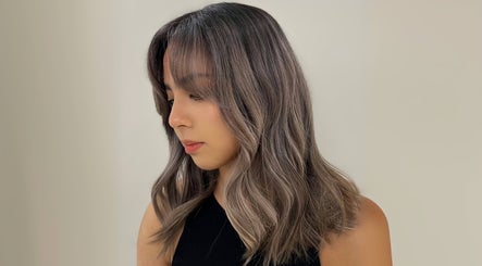 Woman with chic wavy hairstyle at Cosmo Hair Salon in Melbourne, Victoria, AU.